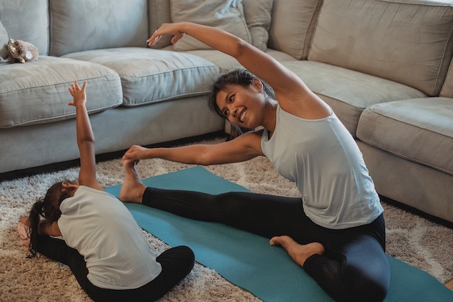 https://www.pexels.com/photo/cheerful-asian-mother-and-daughter-stretching-body-in-living-room-5094673/